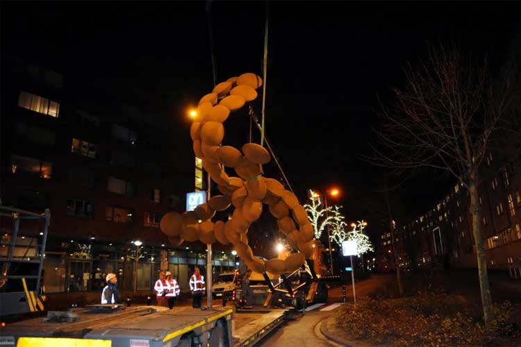 Het cor-ten stalen beeld van Pieter Obels wordt getransporteerd op de rotonde in Spijkenisse - centrum. foto © CoCo-Pictures